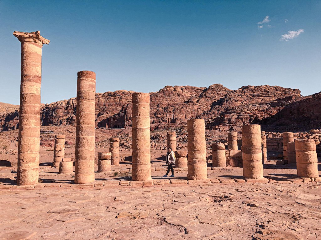 Me walking through a series of columns at Petra
